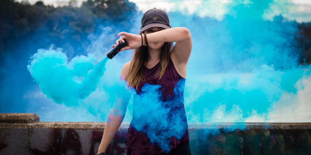 women holding a smoke flare